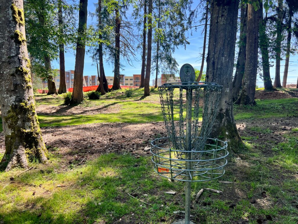A picture of the frisbee golf course at Church Creek Park with the Cedarside Community in the background.